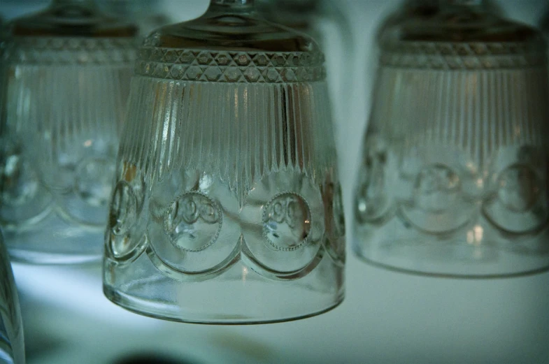 a group of glass cups with a little statued person