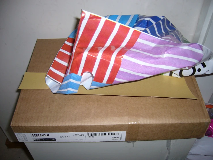 a pair of folded towels sitting on top of a box