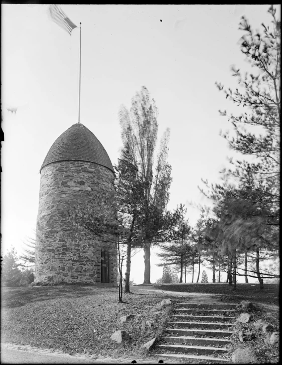 an old brick structure with a flag on it