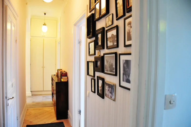 a hallway with a few black and white pictures