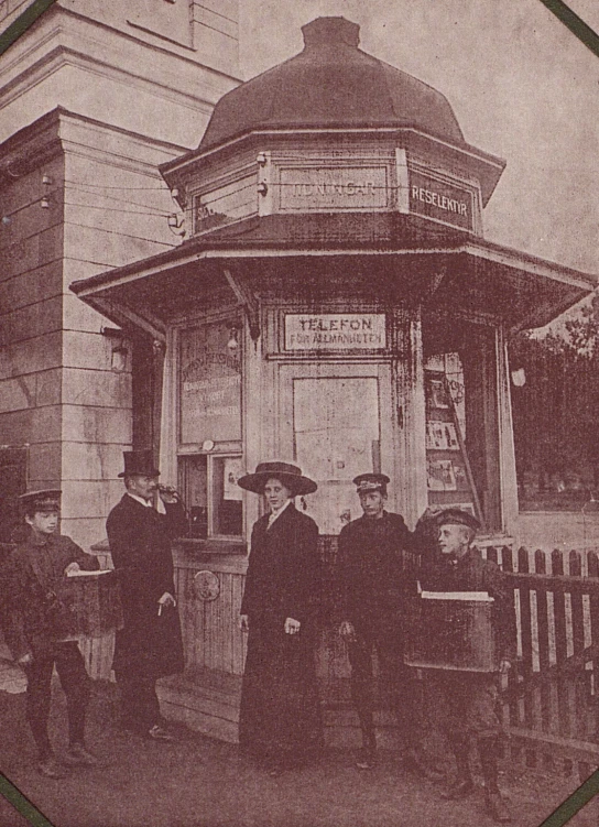 black and white pograph of men standing outside a small building