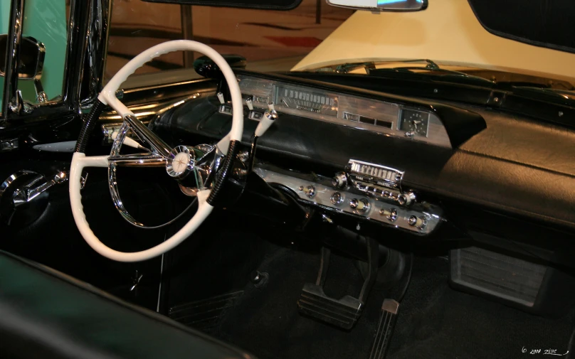 an old fashion car with a steering wheel and dashboard