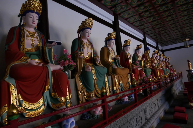 several golden statues sitting in the corner