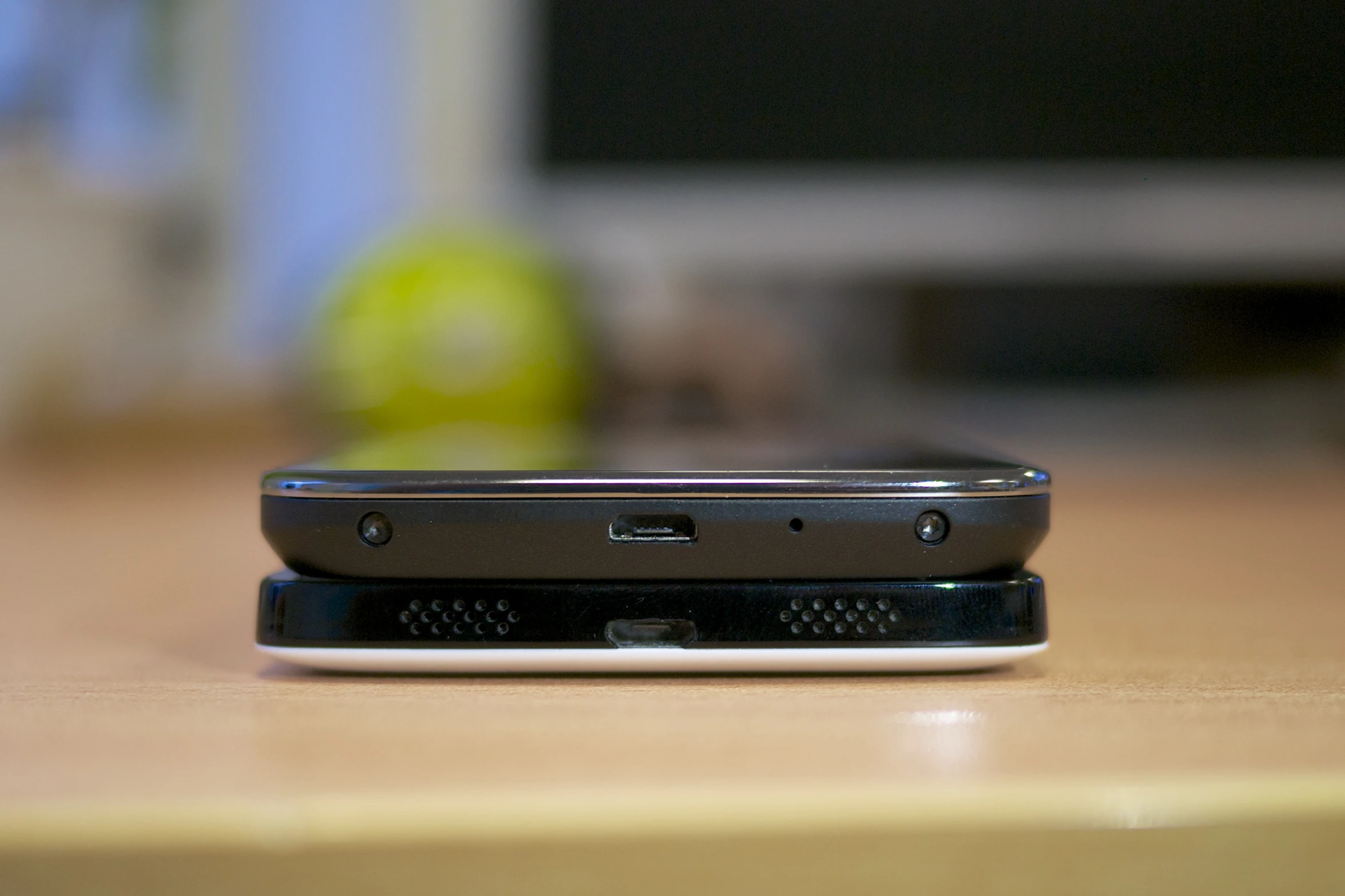 a silver cell phone on top of a table