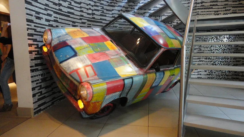 colorfully painted car with open trunk parked at the top