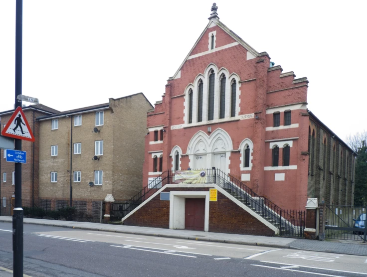 an old red brick building with white trim