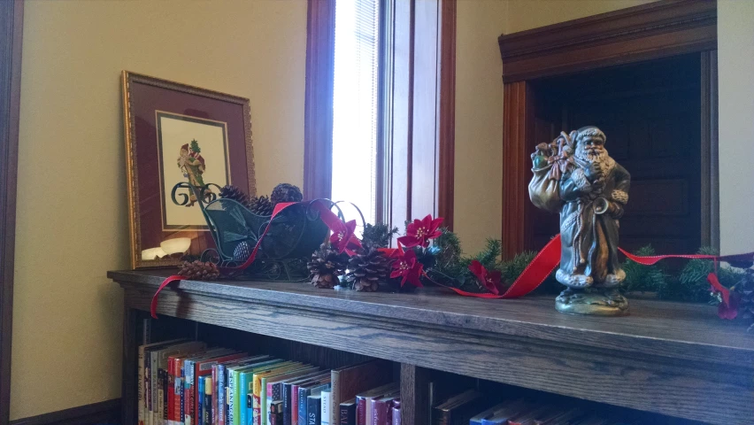 an ornate book shelf is decorated with holiday decorations