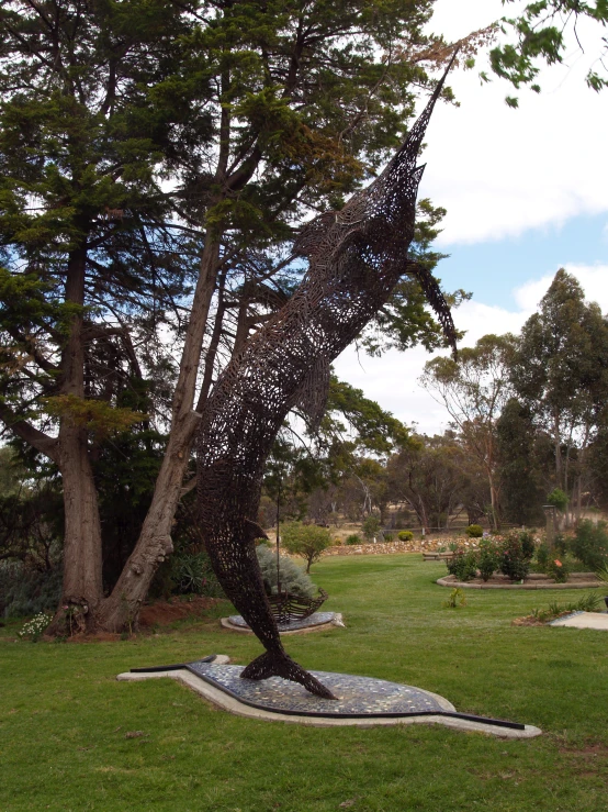 the sculpture is in the shape of a lizard on the rock