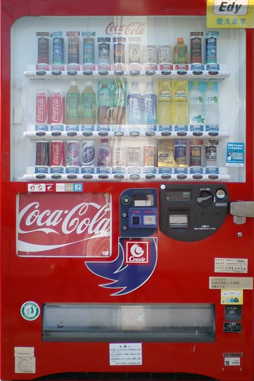 a red vending machine with drinks on top of it