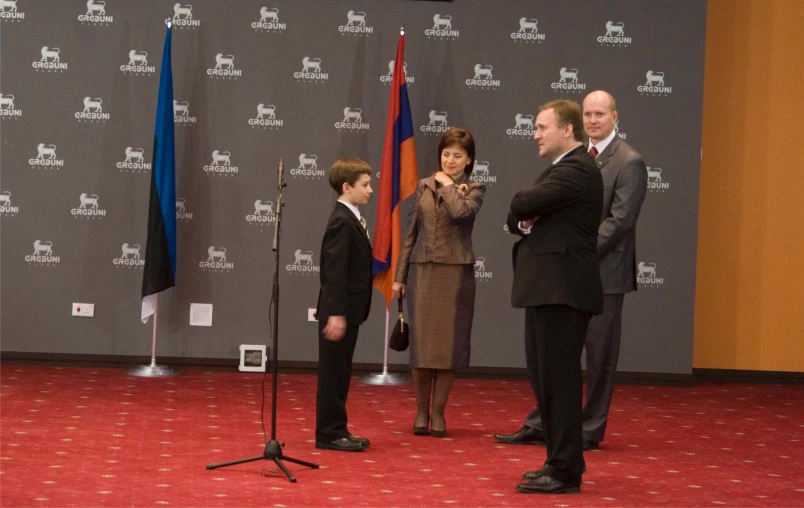 some people standing on stage with two men and a child