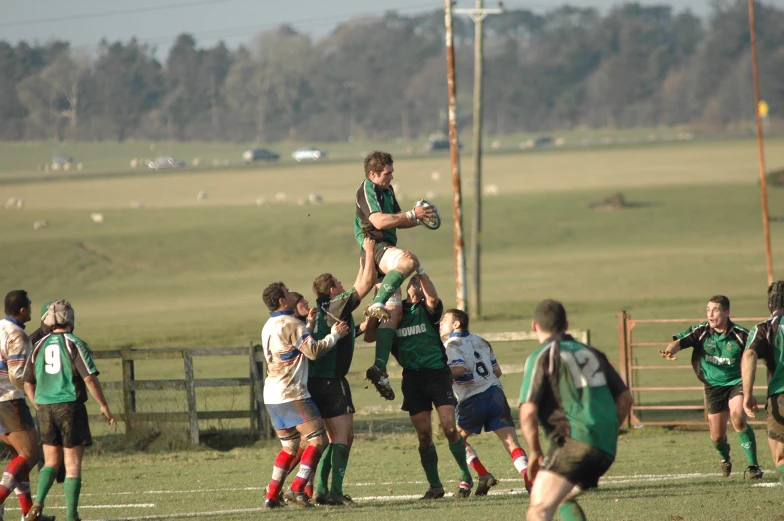 there is a crowd watching as the rugby players celete