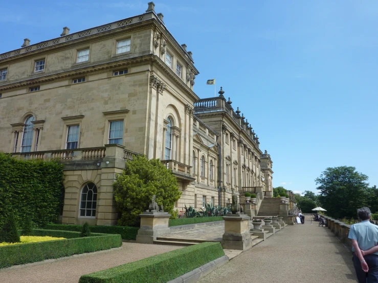 a big building has trees on each side and some steps