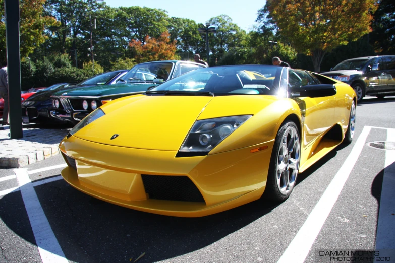 two exotic cars parked on the side of the road