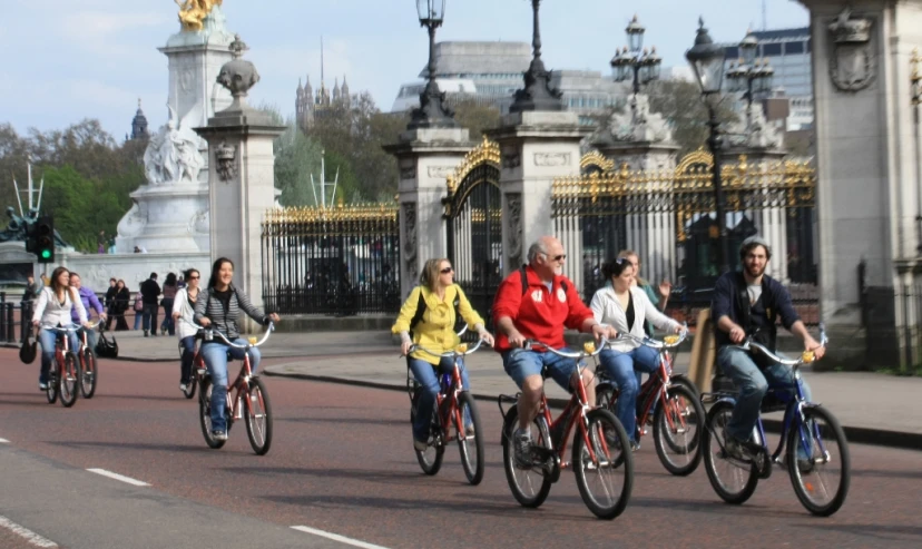 four people are riding bikes down the street