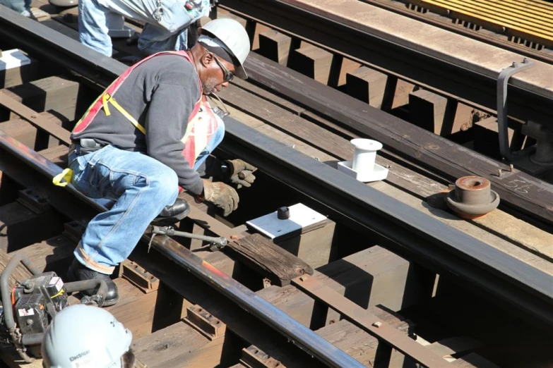 two men working on railroad tracks next to each other