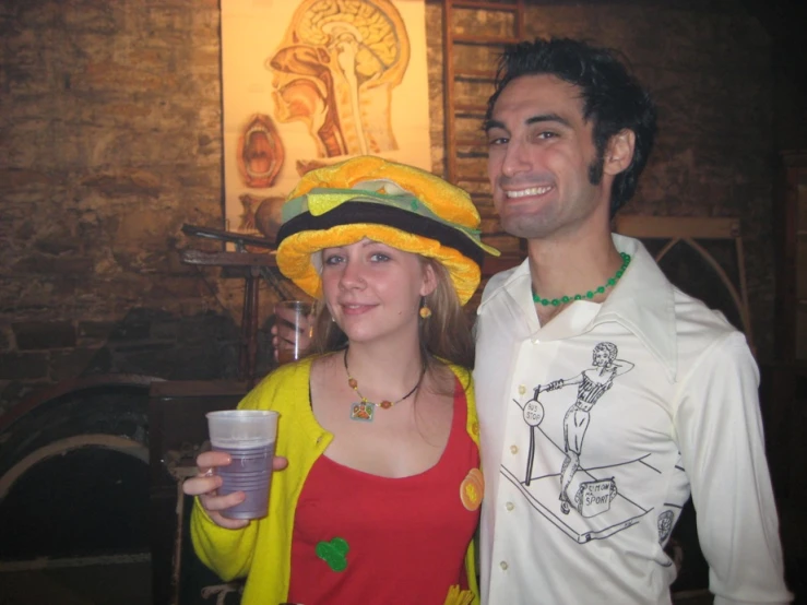 man and woman with sunflower hat holding drinks