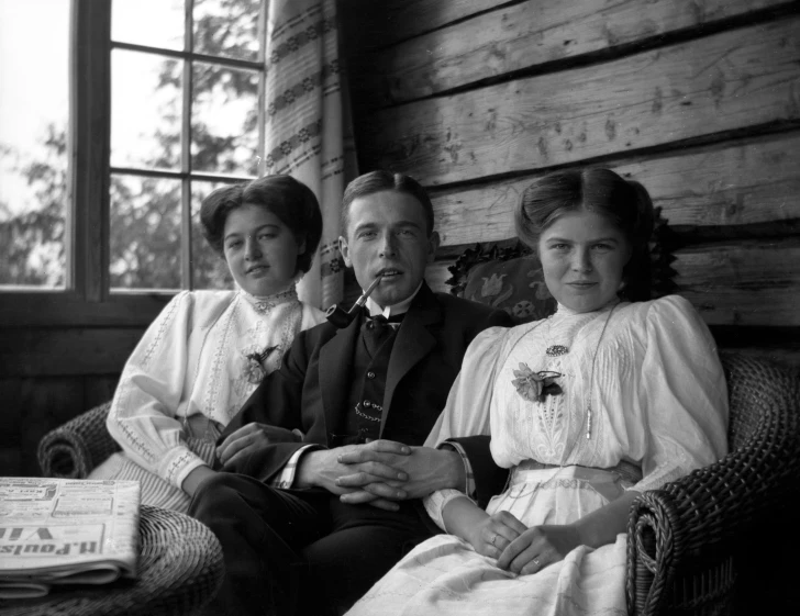 three people are sitting in a chair together