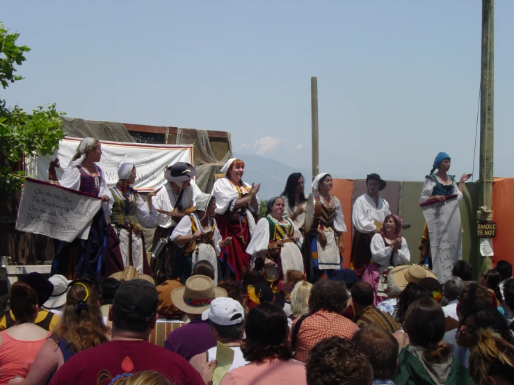 several people are performing in front of an audience