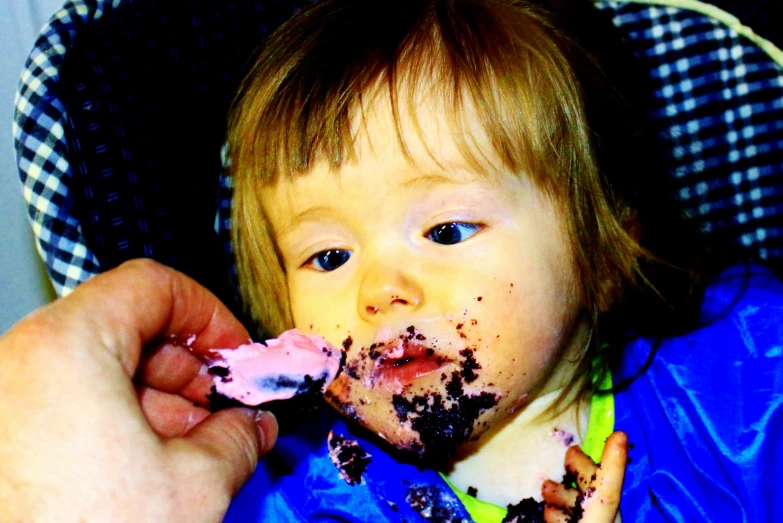 there is a small child eating a piece of cake