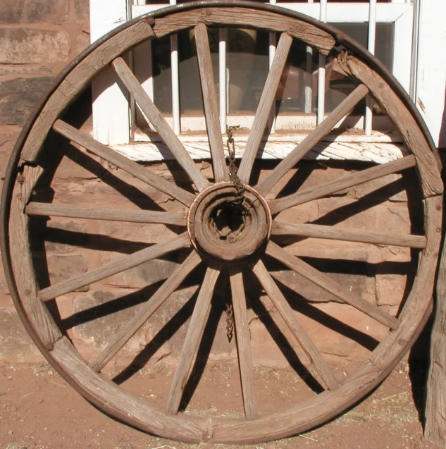 an old wooden cart wheels are displayed in this antique pograph