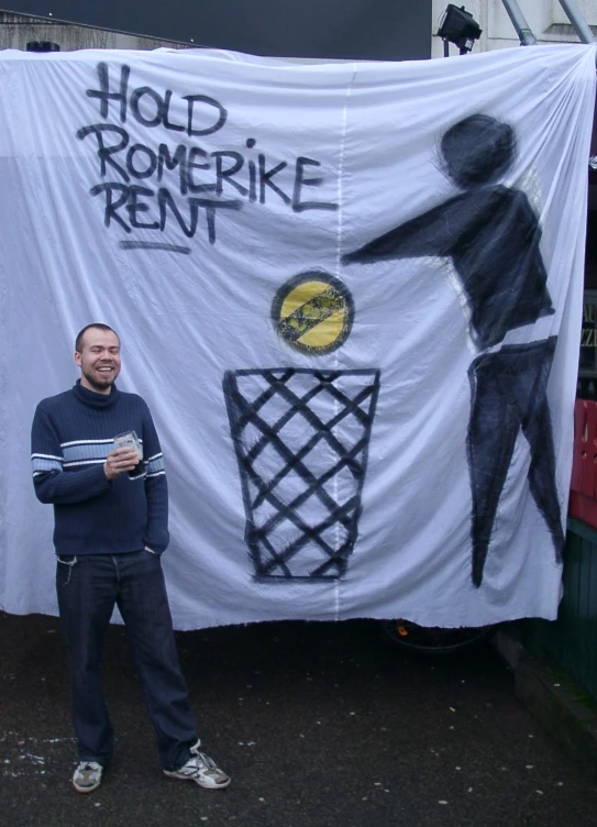 a man in front of a sign for a rental house