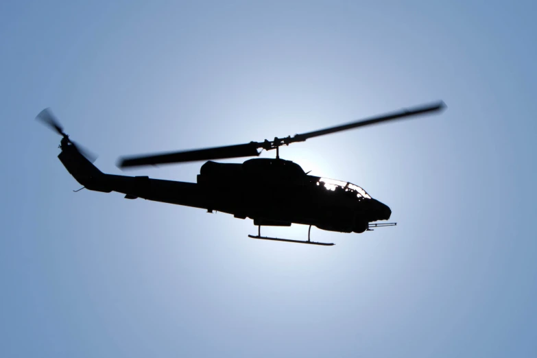 the shadow of the helicopter against a clear blue sky