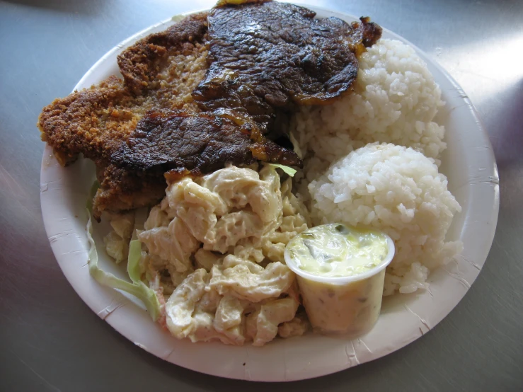 a plate of food that has some chicken, and rice on it