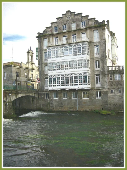 there is a building with many windows along side a river