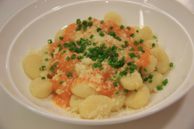 a bowl with some vegetables in it, with tiny crumbs