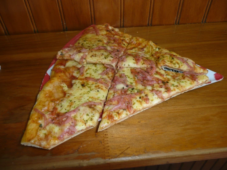 the pizza is sitting on the table sliced into four pieces