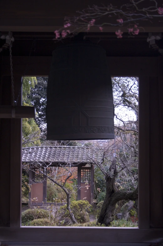 the bell is hanging outside of the window in the building