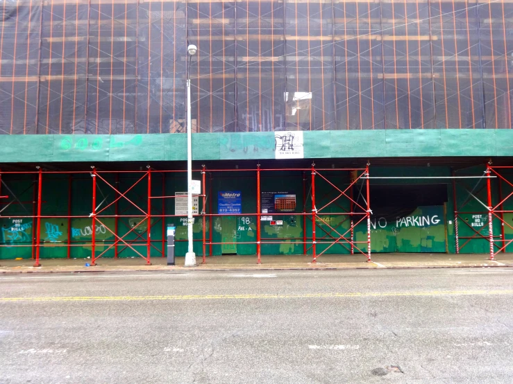 some scaffolding near a green and brown building