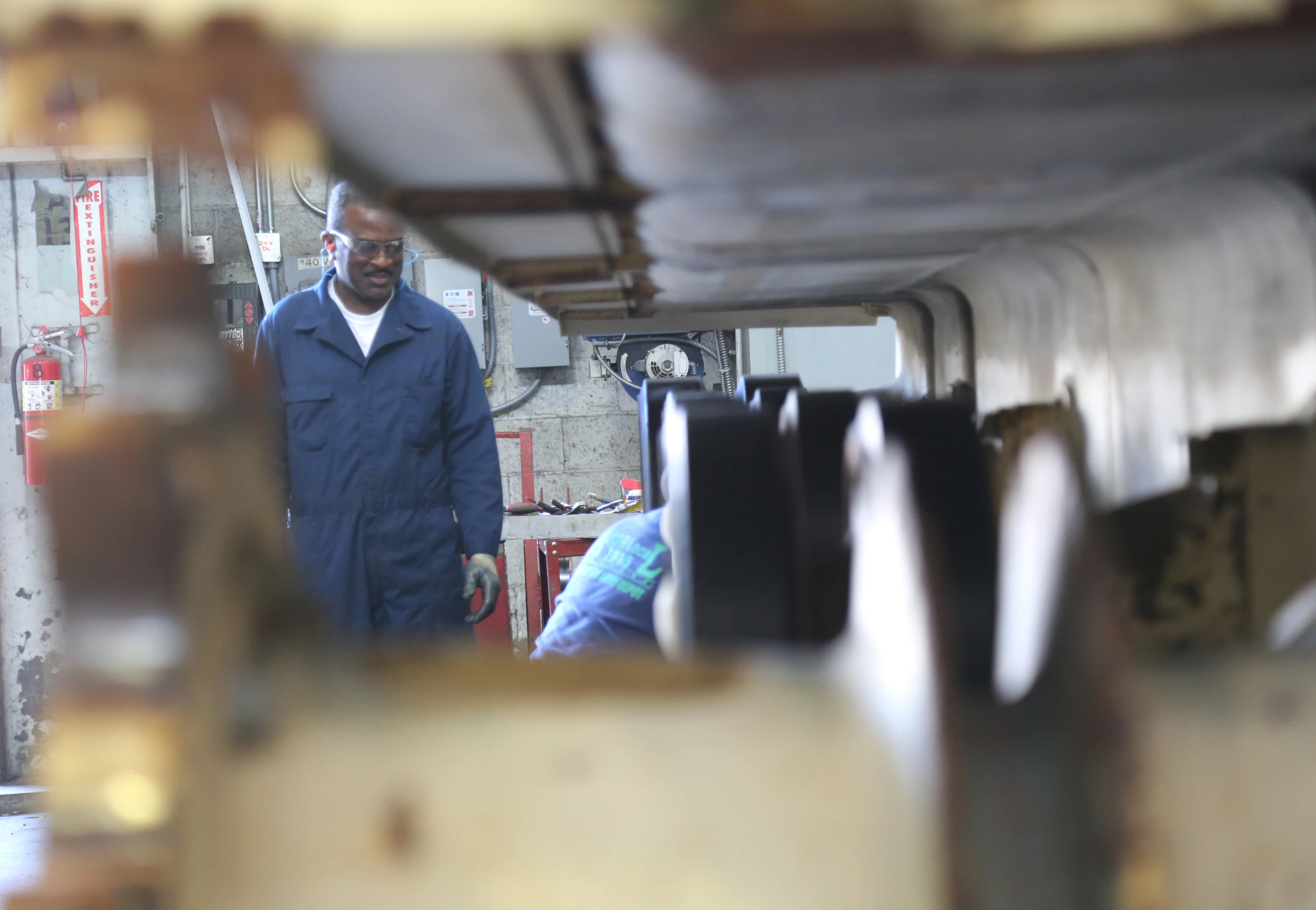 a man in blue is walking through the building