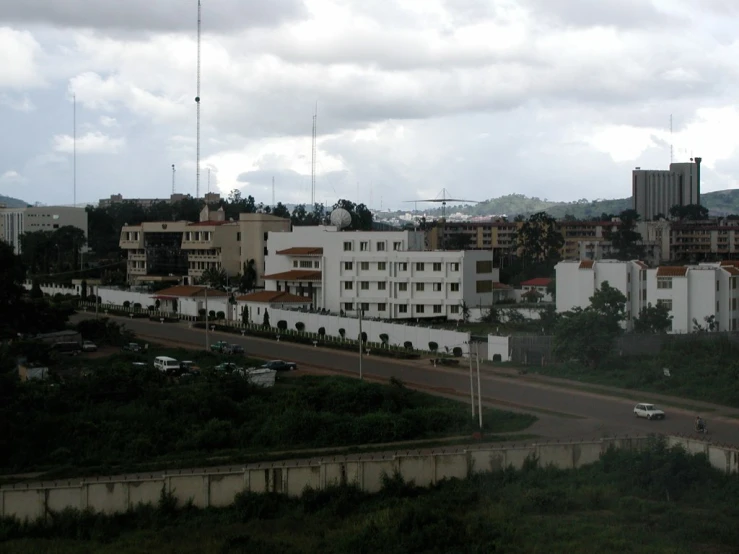 a road lined with large buildings in the background