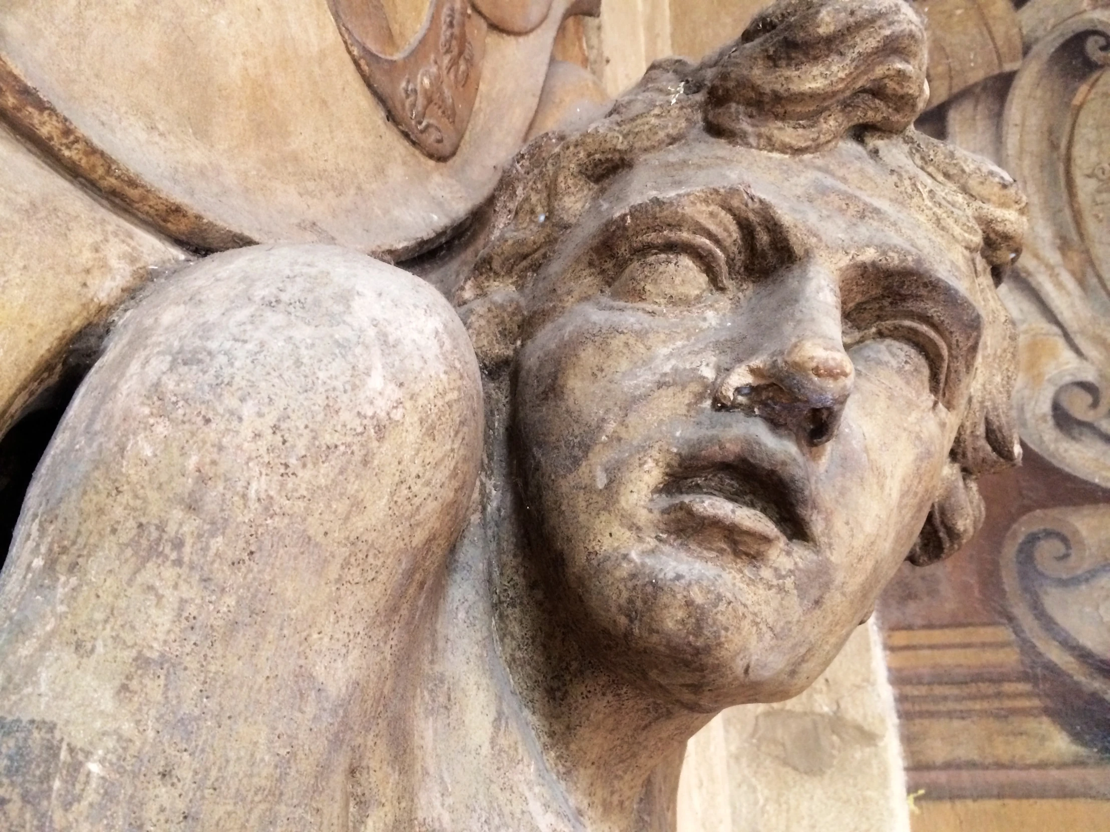 a stone bust of an angel with a face made of marble