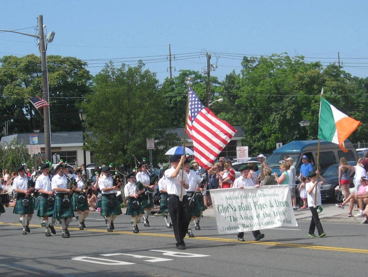 a group of people holding flags on a street