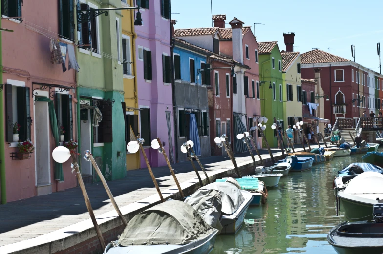 many boats parked in the canal of town