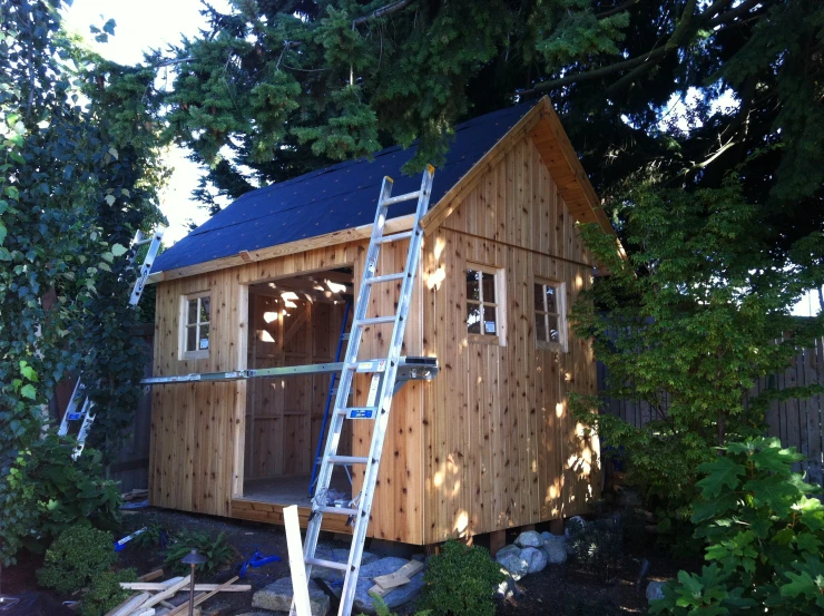 a house being built and under renovation by a ladder