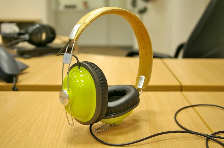 a pair of headphones is on the wooden desk