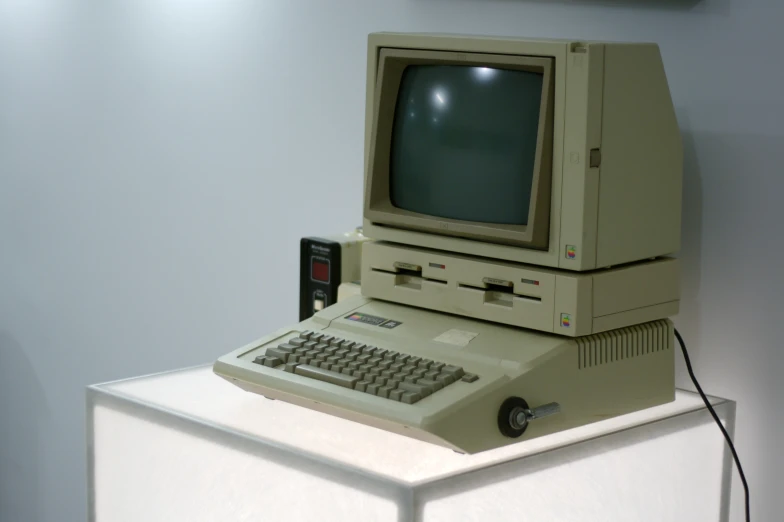 a computer is sitting on top of a refrigerator