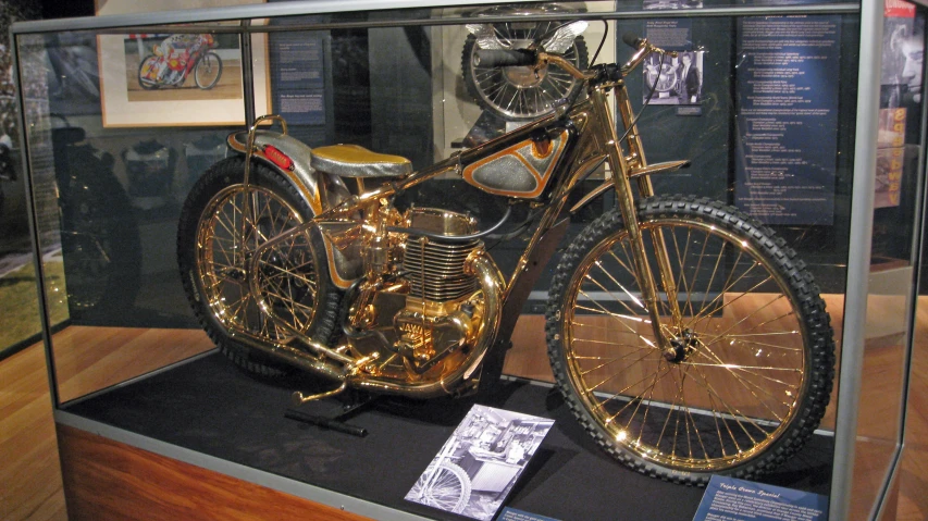 an antique motorcycle parked in a display case