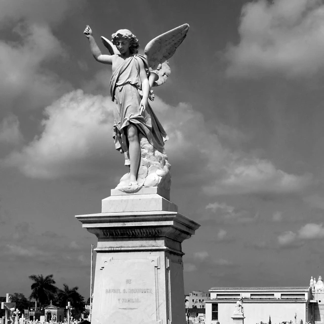 a black and white po of a statue of an angel