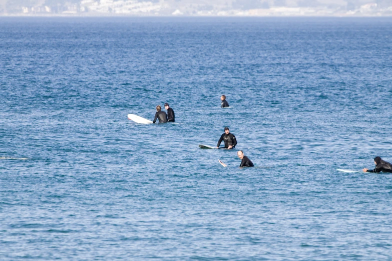 a group of people standing in the ocean