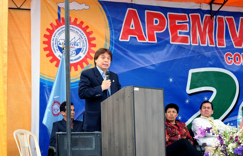 a person standing in front of a podium at a microphone