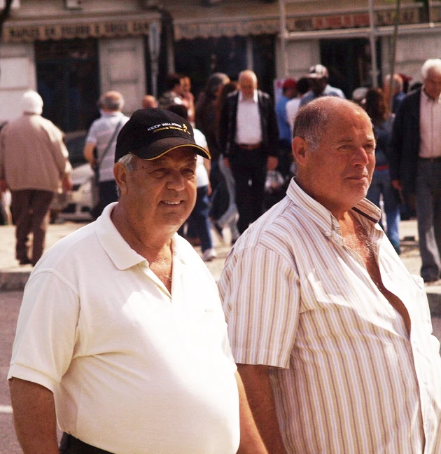 an older gentleman is standing next to an older gentleman