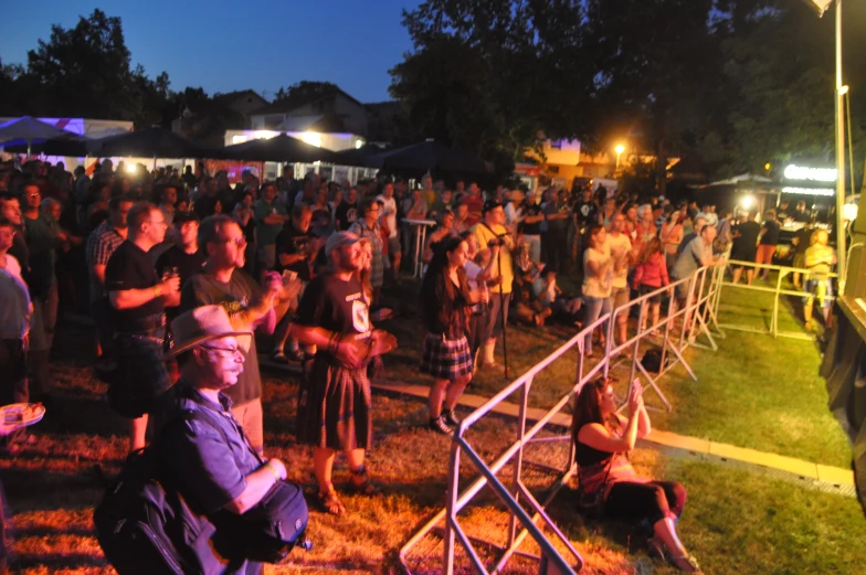 a crowd of people sitting and standing in front of people