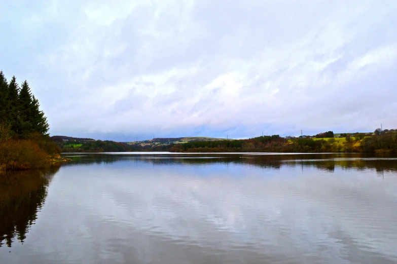 a lake with clear water surrounded by woods