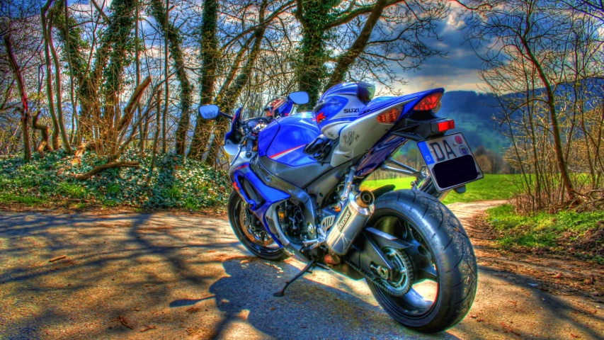 a close up of a motorcycle parked near trees