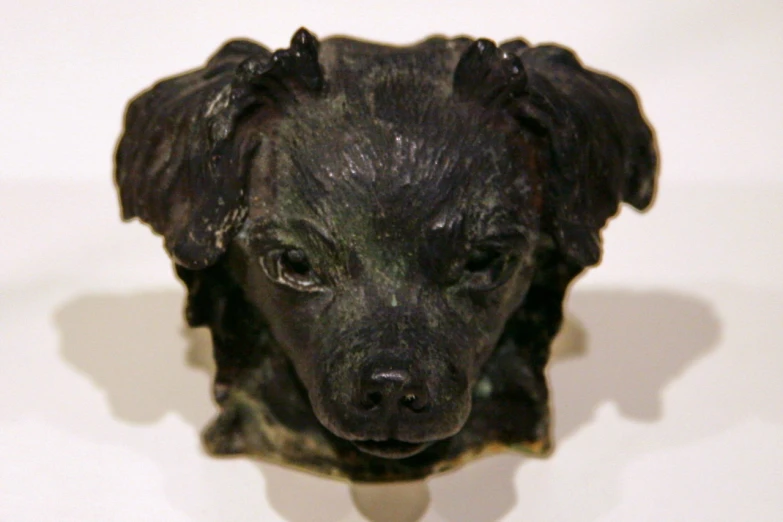 a statue of a dog on display in a museum