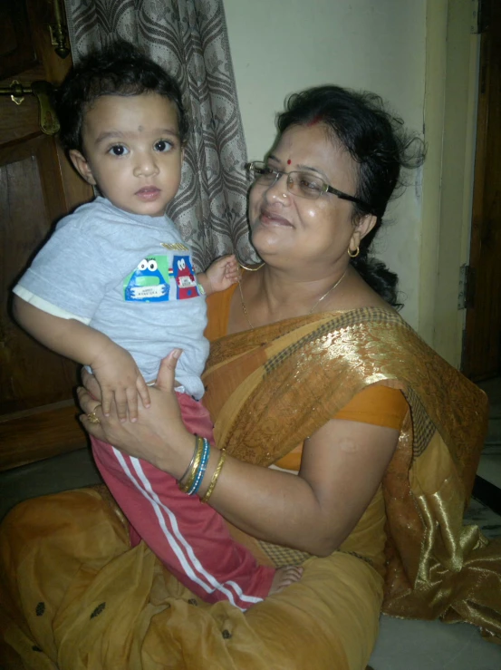 a woman sitting down with a child in her lap